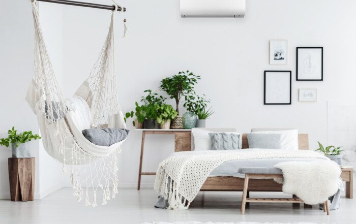 A cozy bedroom with a ceiling hammock, featuring the Daikin new Cora heat pump