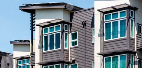 A row of apartment buildings with windows.