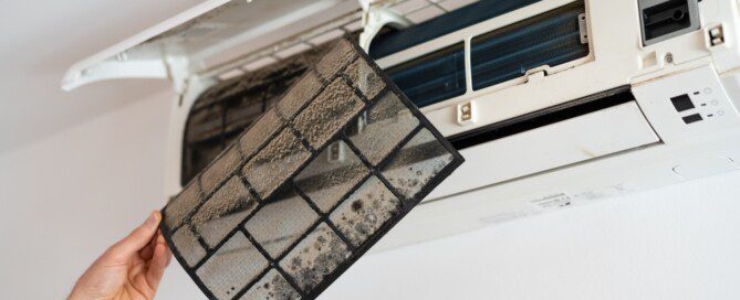 Air conditioner filter dusty. Preparation for maintenance and cleaning.