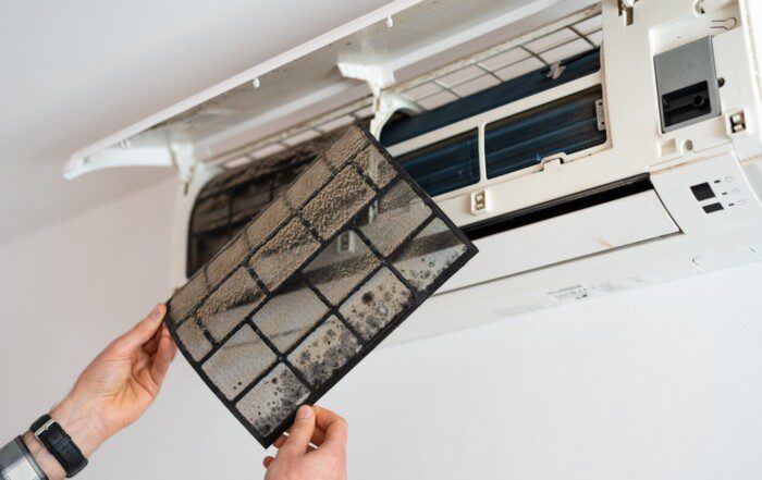 Air conditioner filter dusty. Preparation for maintenance and cleaning.